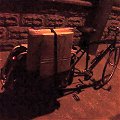 Xtracycle carrying parceled paintings at night