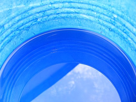 Blue sky reflected in a can of blue paint