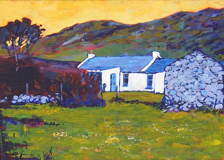 Irish whitewashed cottage seen from sheepfield to the front